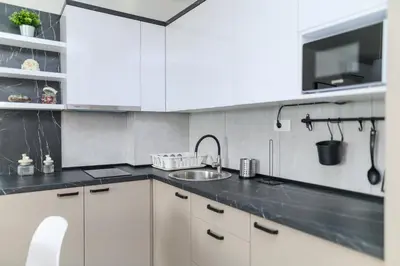 a kitchen with white cabinets and a sink at AQUA LUX - Green Hill - Kod akva parka Podina in Soko Banja