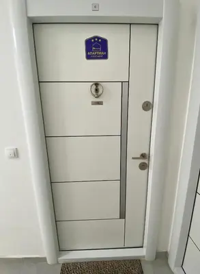 a white cabinet with a blue sign on it at Apartman Nest in Vranje