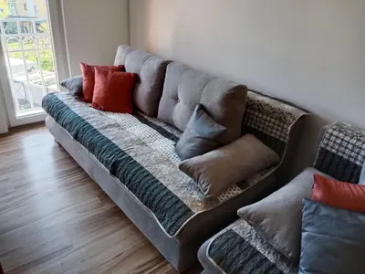a couch with pillows on it in a living room at Apartman 4M in Vrnjačka Banja