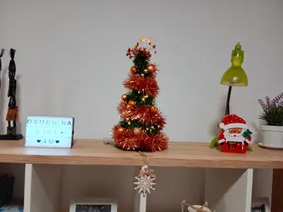 a small christmas tree on a wooden shelf at Apartman 4M in Vrnjačka Banja