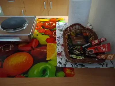 a basket of candy in a pile of fruits and vegetables at Apartman 4M in Vrnjačka Banja