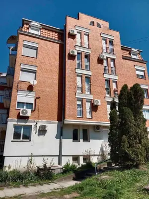 a tall building with a red brick at Apartman 4M in Vrnjačka Banja