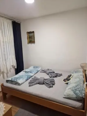 a bed with two pairs of gloves on it at Apartman Tupavica in Pirot