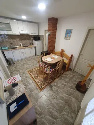 a kitchen and dining room with a table and chairs at Apartman Tupavica in Pirot