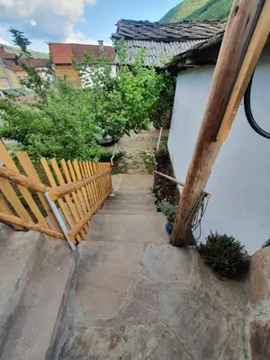 a stairway with a wooden bench next to a building at Apartman Tupavica in Pirot