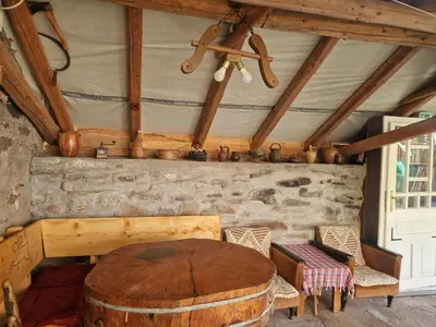 a dining room with a wooden table and chairs at Apartman Tupavica in Pirot