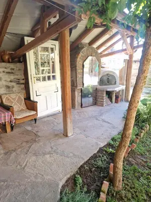 an outdoor patio with a door and a stove at Apartman Tupavica in Pirot