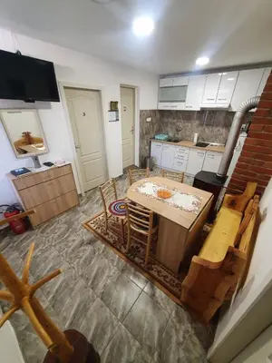 a kitchen with a table and chairs in it at Apartman Tupavica in Pirot