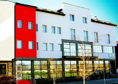 a building with red paint on the side of it at Garni Hotel Crystal Ice in Niš