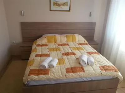a bedroom with a bed with a quilt on it at Garni Hotel Crystal Ice in Niš
