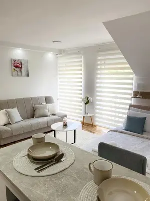 a living room with a couch and a table at La Perla Apartman in Vrnjačka Banja