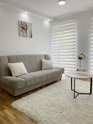 a living room with a couch and a table at La Perla Apartman in Vrnjačka Banja