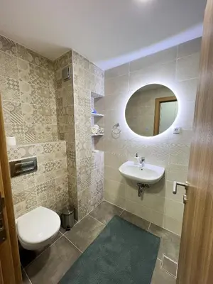 a bathroom with a sink and a toilet and a mirror at A1 Miladinovic in Kraljevo