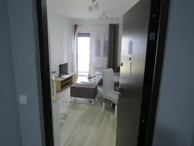 an open door to a room with a living room at Aqua Lux Apartman in Jagodina