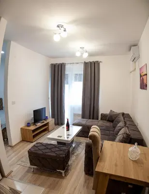 a living room with a couch and a table at Aqua Lux Apartman in Jagodina