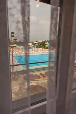 a view of a swimming pool from a train window at Aqua Lux Apartman in Jagodina