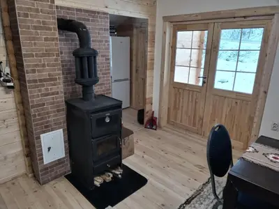 a stove in a room with a brick wall at Milica 2 Mezdrejska 87 A in Crni Vrh