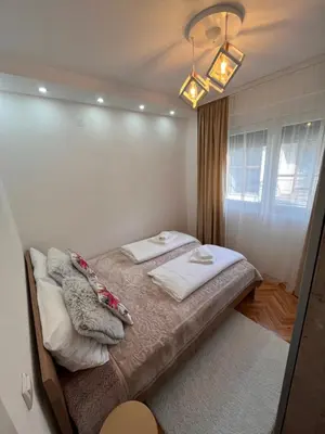 a bedroom with a bed with two pillows on it at Apartman Polo in Jagodina