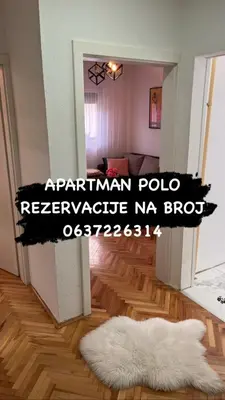 a room with a white rug on a wooden floor at Apartman Polo in Jagodina