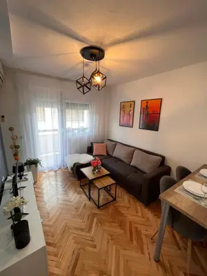 a living room with a couch and a table at Apartman Polo in Jagodina