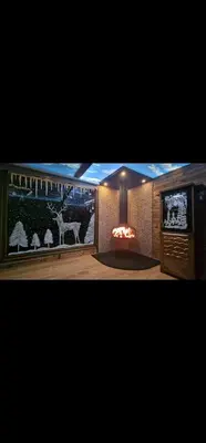 a living room with a tv and a fireplace at Magareće Mleko Eko Farma Sisevac Wellness&Spa in Paraćin