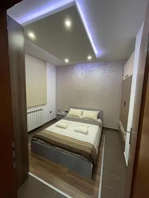 a small bedroom with a bed in a room at Apartman IN in Vrnjačka Banja