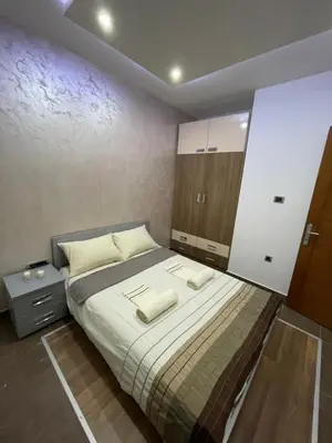 a bedroom with a bed with two towels on it at Apartman IN in Vrnjačka Banja
