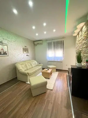 a living room with a couch and a table at Apartman IN in Vrnjačka Banja