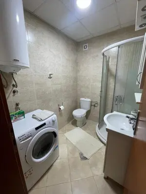 a bathroom with a washing machine and a sink at Apartman IN in Vrnjačka Banja