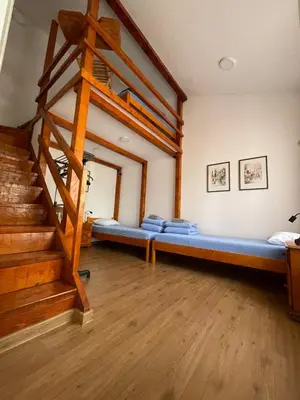 a room with a blue bed and a staircase at Rustic Villa in Jagodina