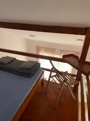 a bed and a wooden chair in a room at Rustic Villa in Jagodina