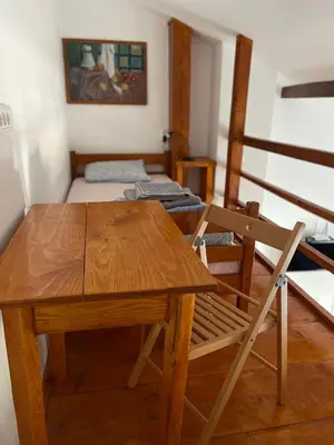 a wooden table and a chair in a room at Rustic Villa in Jagodina