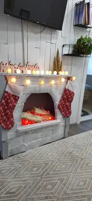 an outdoor fireplace with christmas decorations on top of it at Queen Apartmančić in Zaječar