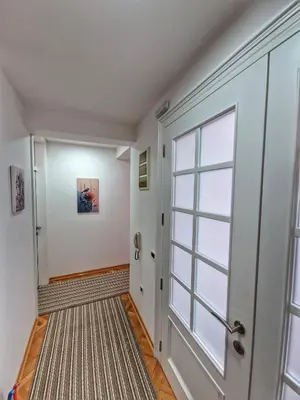 a hallway with a door and a window at Apartman Cvetkovic in Vranje