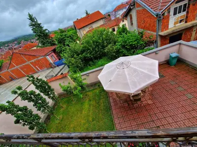 an umbrella sitting on top of a balcony at Apartman Cvetkovic in Vranje