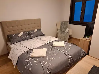 a bedroom with a bed with two towels on it at Apartman Imperator Vrnjačka Banja in Vrnjačka Banja