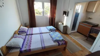 a small bedroom with two beds and a window at Soba Soko in Soko Banja