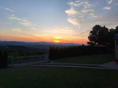 a sunset over the mountains from a house at Apartmani Milosavljević in Kuršumlija
