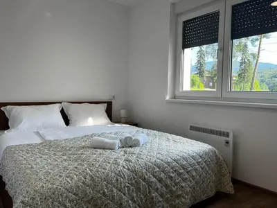 a bedroom with a bed with two towels on it at Apartman Sunce in Vrnjačka Banja
