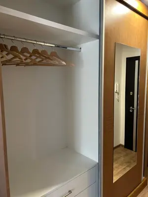 a dressing room with a mirror and a closet at Apartman Sunce in Vrnjačka Banja