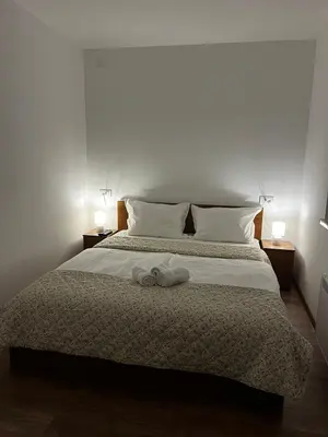 a bedroom with a bed with two towels on it at Apartman Sunce in Vrnjačka Banja
