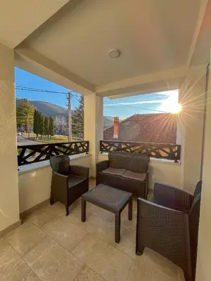 a balcony with chairs and a table and a view at Vila Sunset in Soko Banja