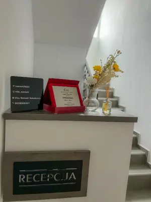 a shelf with a red box and flowers on it at Vila Sunset in Soko Banja