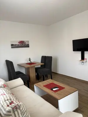 a living room with a couch and a table at Vila Sunset in Soko Banja