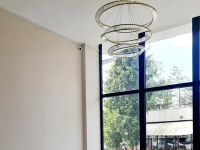a room with a large window and a chandelier at RELAX LUX AKVA PARK 2(K-KOMPLEX) in Jagodina