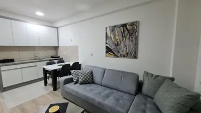 a living room with a couch and a kitchen at RELAX LUX AKVA PARK 2(K-KOMPLEX) in Jagodina
