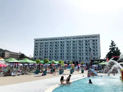 a group of people in a swimming pool with a building at RELAX LUX AKVA PARK 2(K-KOMPLEX) in Jagodina