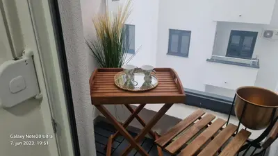 a small wooden table with two cups on top of it at RELAX LUX AKVA PARK 2(K-KOMPLEX) in Jagodina