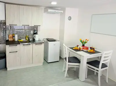 a kitchen with a table and chairs in a room at Жути Ранац - Žuti Ranac - Yellow Backpack in Boljevac