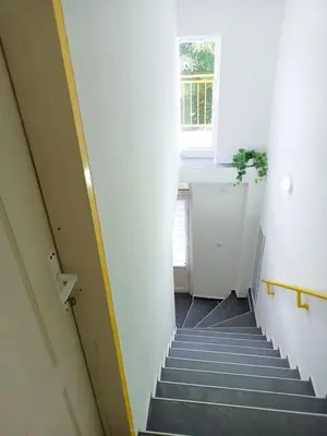 a hallway with stairs with a window and a sink at Жути Ранац - Žuti Ranac - Yellow Backpack in Boljevac